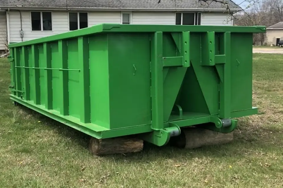 Roll-off dumpster set on wooden boards on a lawn